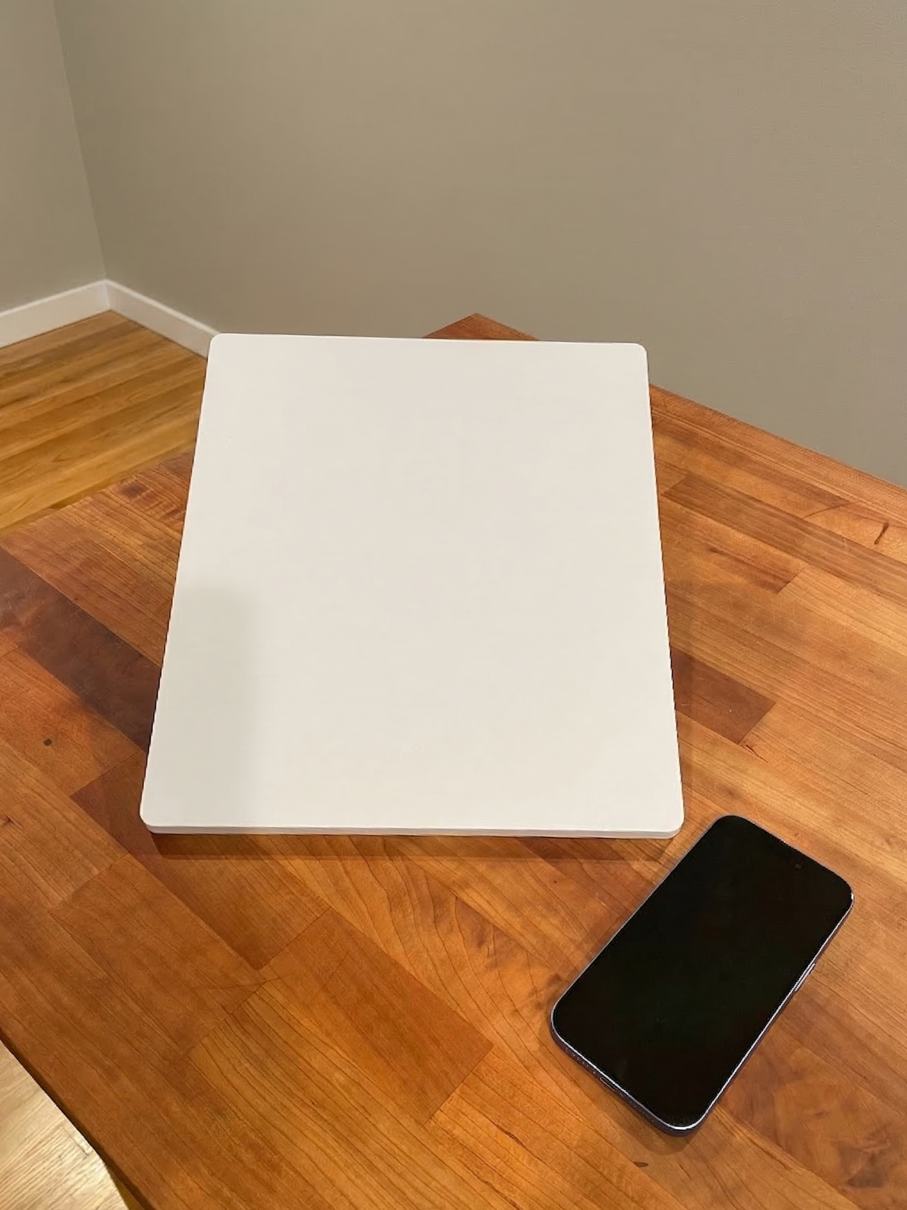 A smartphone next to a Starlink Mini